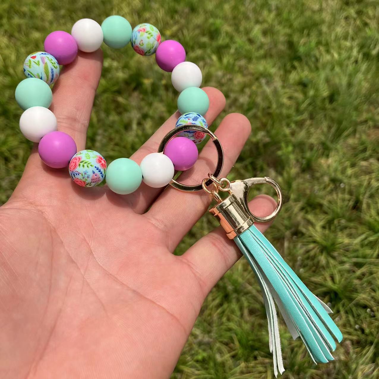 Comercio al por mayor leopardo girasol borla de silicona con cuentas llavero de muñeca